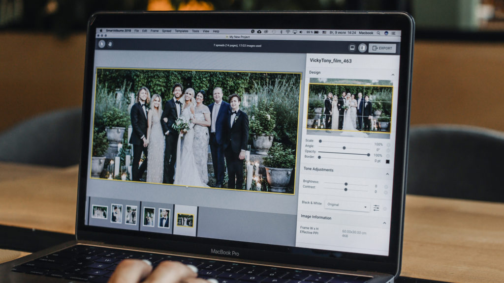 wedding photographer creating wedding album on computer