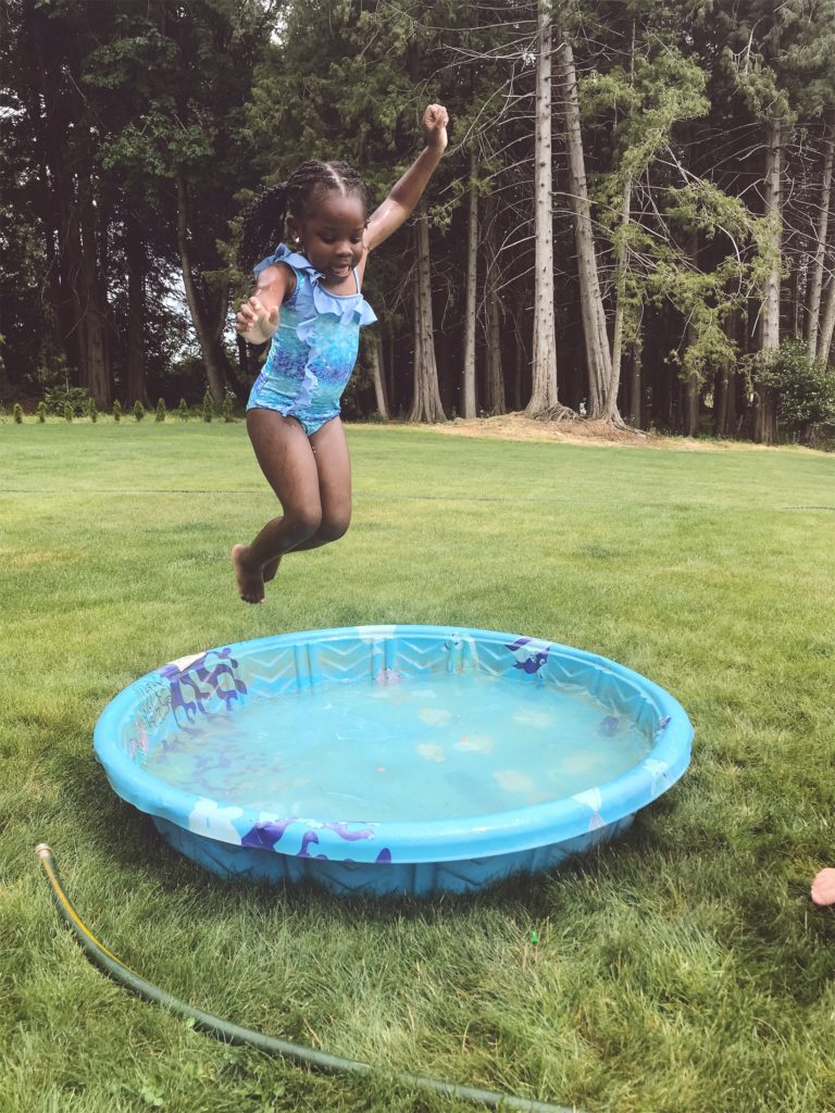 kid jumping into plastic pool